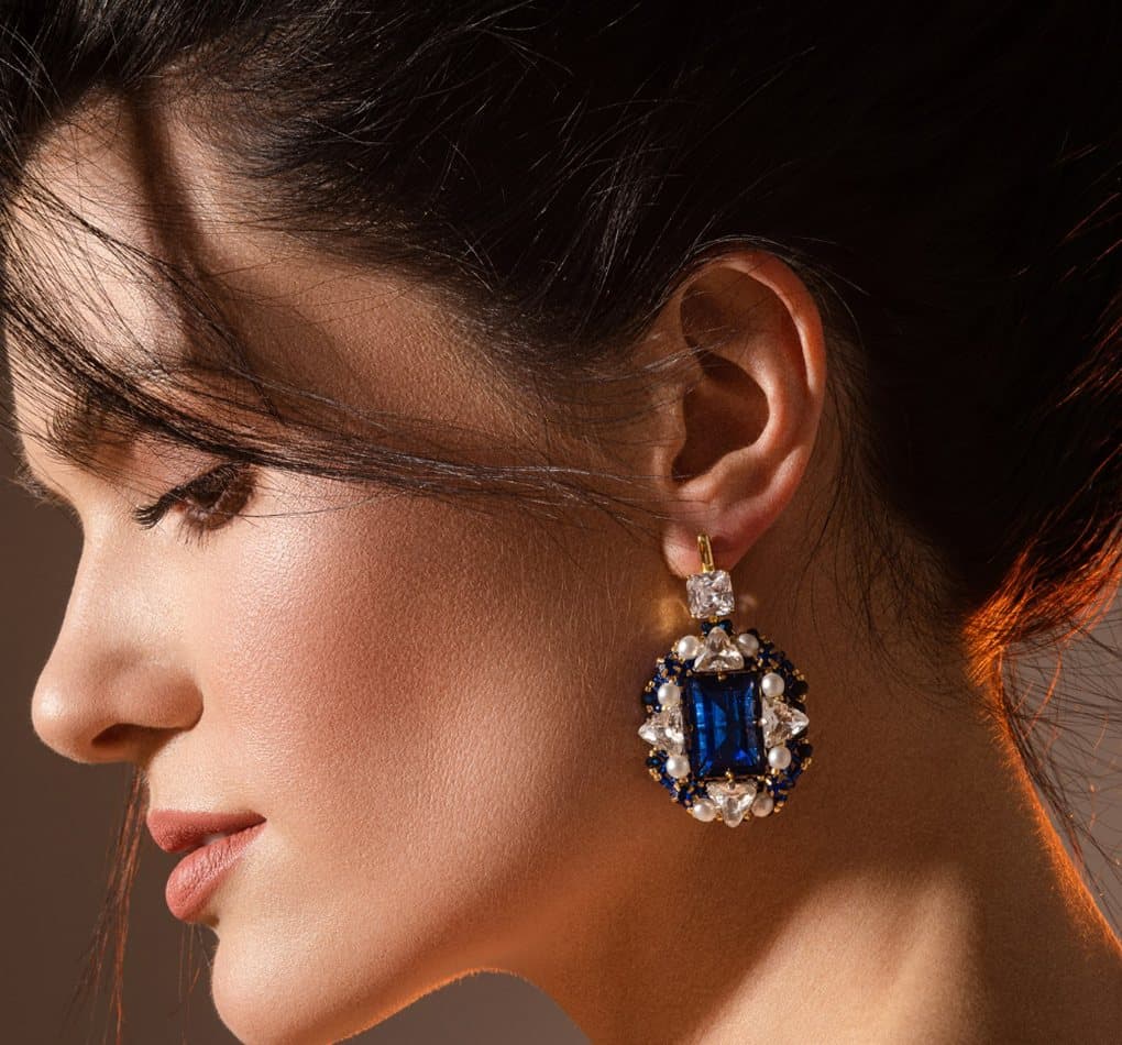 Model wearing an Aurora sapphire earring